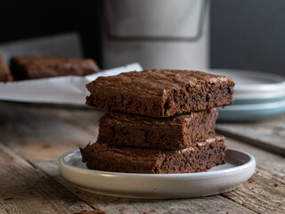 stack of chocolate brownies on a rustic table