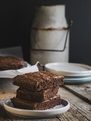 stack of chocolate brownies on a rustic table
