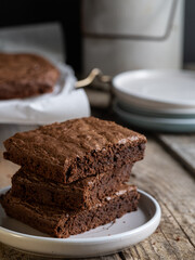 stack of chocolate brownies on a rustic table