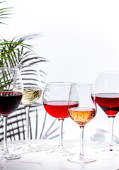 Non-alcoholic, alcohol free wine set. Red, white, rose wines in glasses. White background, shadows,...