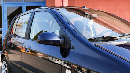 Fototapeta premium Clean and shiny car parked near car wash building