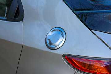 Close-up Detail of White Car Body with Circular Turn Signal Light and Red Taillight Design