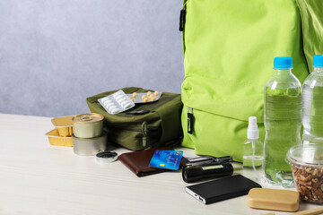 Survival kit. Different emergency supplies on white wooden table, closeup