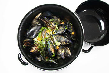 steamed dutch mussels in cream sauce pot with white background