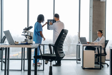 X-ray in hands, researching. Doctors are in the clinic