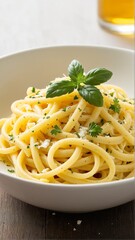 A Bowl of Bucatini Pasta Sprinkled with Fresh Herbs and Cheese, Topped with Vibrant Basil Leaves, a Classic Italian Culinary Delight