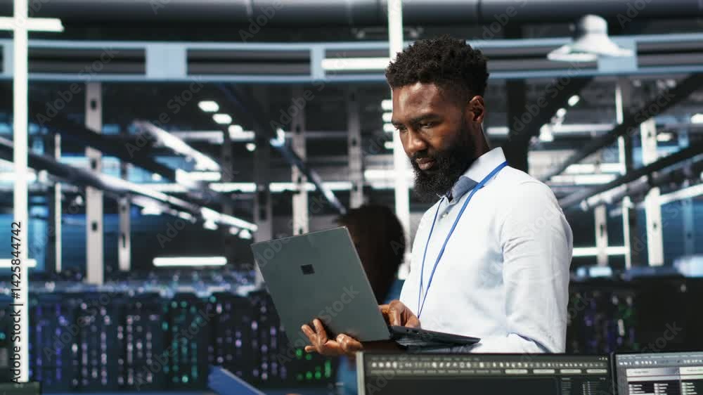Poster happy data center admin uses node tree programming on laptop to identify equipment performance issue