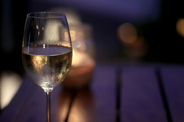 a glass of cold white wine and serving in the restaurant