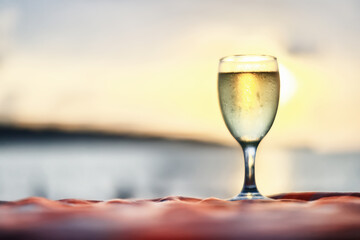 a glass of white wine on the background of the sea relaxing by the sea with wine