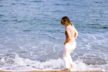 Woman with continuous glucose monitor enjoying spring day at beach