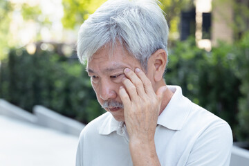 Asian elderly senior man with eyesight issue, concept image of aging eye sight, vision deterioration, elderly seeing, eyesight impair, optical problem
