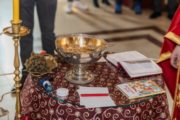 Orthodox Baptism Ceremony Preparation with Holy Water and Religious Items