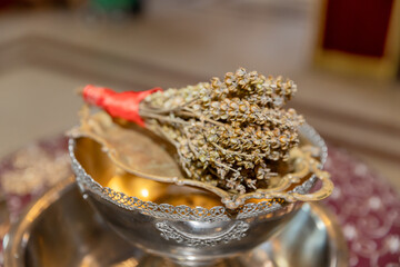 Orthodox Ritual Items: Dried Herbs, Holy Water, and Silver Bowl
