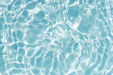 Blue water with ripples on the surface. Defocus blurred transparent blue colored clear calm water surface texture with splashes and bubbles. Water waves with shining pattern texture background.