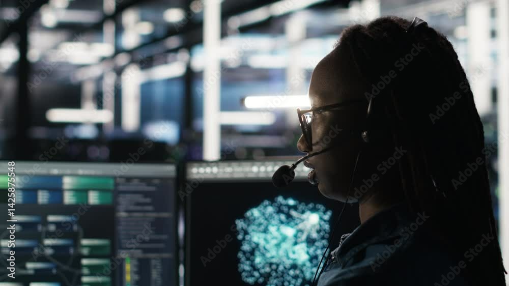 Poster data center employee uses audio headset and visual programming dashboard to troubleshoot client repo