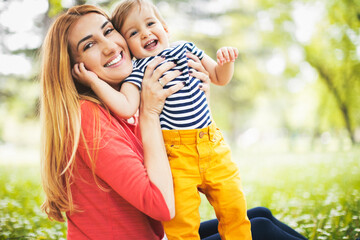 Portraits of happy family outdoors with their baby boy. Shallow DOF. Developed from RAW; retouched...