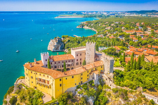 A stunning aerial view of famous place in Italy, dramatically set atop coastal cliffs overlooking the Adriatic Sea, surrounded Mediterranean landscape, blending noble history with breathtaking views