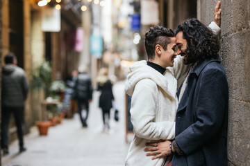 Fototapeta premium Gay couple sharing a romantic moment in a city street