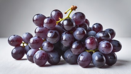 Fototapeta premium Fresh Ripe Black Seedless Grapes on White Background