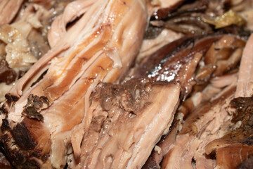 Close up of slow cooked lamb meat leg for a roast dinner on a wooden choping board