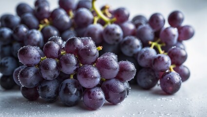 Fototapeta premium Juicy black grapes on a white background, perfect for snacking or cheese pairing.