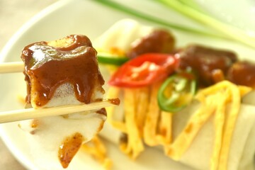 fresh Chinese spring roll made from flour wrapped tofu and pork with bean sprout dressing sweet red gravy sauce on plate   
