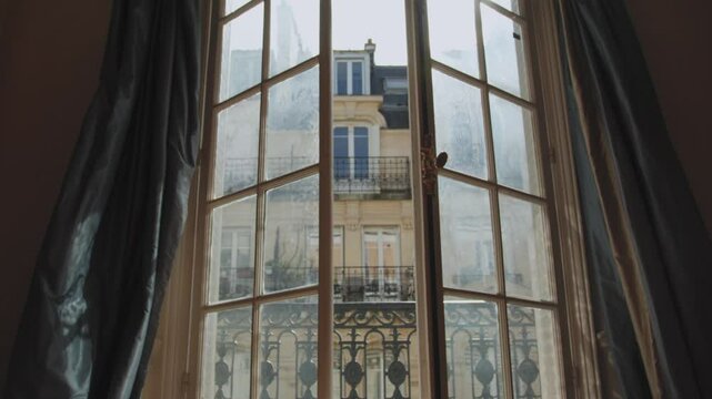 Opening window reveals parisian building