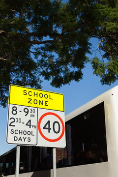 Bus next to school zone sign