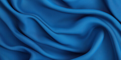 Obraz premium Smooth blue fabric drapes elegantly, showcasing its rich texture and vibrant color. soft folds create sense of depth and movement, evoking feeling of luxury and comfort
