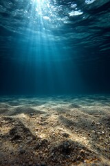 Fototapeta premium Ocean Floor: Sunlight Beams Illuminate Sandy Seabed with Pebbles, Underwater Scene