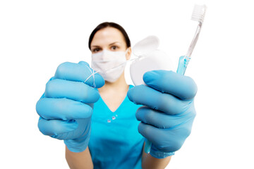 Dentist with tools. The concept of dentistry, whitening, oral hygiene, teeth cleaning with toothbrush and floss. Dentistry, taking care of a beautiful and healthy smile. . Stomatology