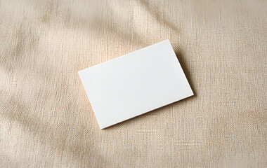 Natural Card Presentation: Blank White Card on a Beige Textile Surface