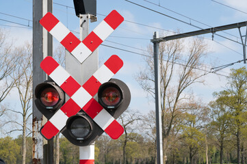 A warning sign indicating a railroad crossing that features bright warning lights for safety