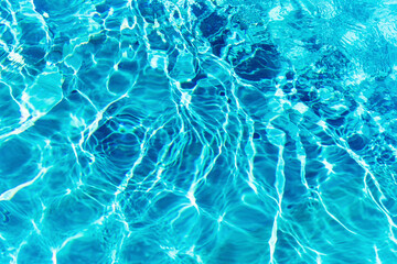 Ripples on the surface of the water in a blue swimming pool