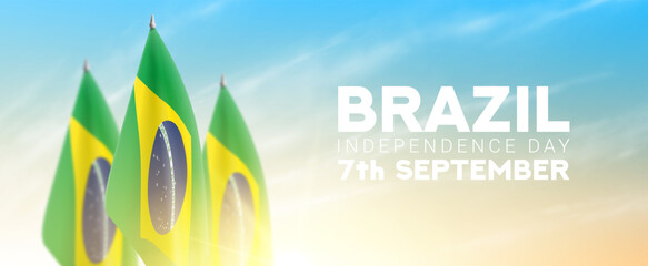 Happy Independence Day of Brazil. Brazilian flags isolated on cloudy sky at sunrise. Realistic flags for decoration Brazilian Independence Day. Vector illustration. Day of Brazil on 7th of September.