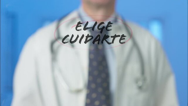 Male doctor writing and circling the spanish words elige cuidarte, which translates to choose to take care of yourself, on a transparent board with a blue background