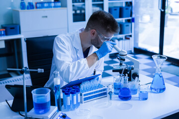 Chemist scientist holding test tube conducting experiment in laboratory with equipment.