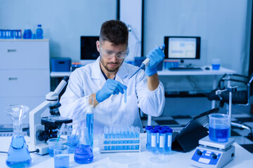 Fototapeta premium Chemist scientist holding test tube conducting experiment in laboratory with equipment.