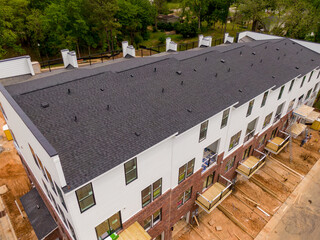 Sunny Daytime Drone Images of New Urban Town Houses and Multifamily Apartments Featuring Asphalt Shingle Roofs.  © Oak City Drone
