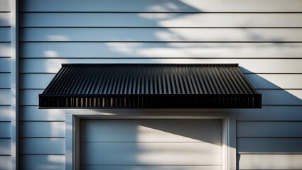 Black metal awning with shadowed door on building exterior