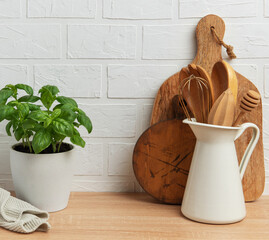 Kitchen utensils and basil plant creating a rustic culinary scene
