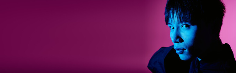 Handsome Asian man exudes charm with striking colors accentuating his stylish presence.
