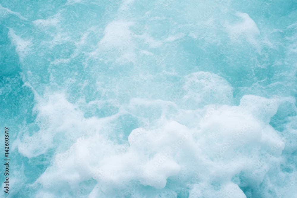 Poster turquoise ocean wave cascades over smooth sandy beach, creating a mesmerizing blend of foam and sunl