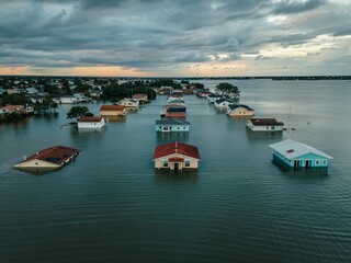 Fototapeta premium Flooded homes in a coastal area after heavy rains impact local community and inhabitants in the region