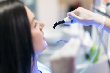 Portraits of doctor and patient in dentist's office. Shallow DOF. Developed from RAW; retouched...