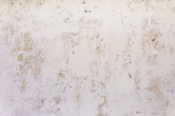 A wall with a lot of dirt and grime on it. The wall is white in color.