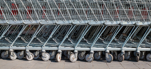 row of empty shopping carts in the big supermarket