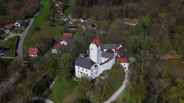 Aerial view of Schloss Elkofen, also known as Burg Elkofen, Schloss Elkhofen, near Grafing bei Muenchen, Germany. A medieval fortress surrounded by green fields in the Bavarian countryside. 