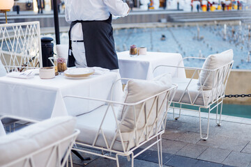 Elegant dining setup with white tablecloth and decorative centerpiece in an upscale restaurant