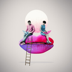 A young man and woman sitting on oversized feminine lips with laptops on their knees and exchanging flirty messages.